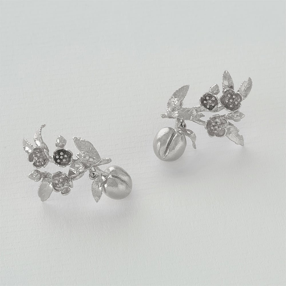 Paper shot of gold Peach Blossom Branch Climber Earrings with Hanging Peaches by Alex Monroe